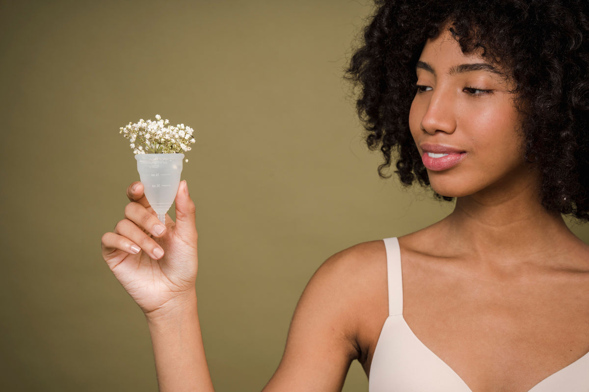 Woman gently holding a small cup of white flowers