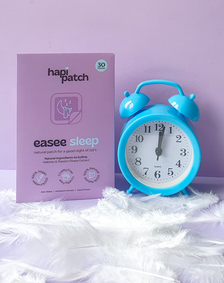 عبوة Hapi Patch Easee Sleep Patches بجانب منبه أزرق على خلفية ليلكية