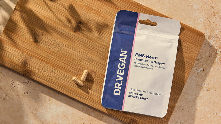 PMS Hero pouch and capsules on a wooden board