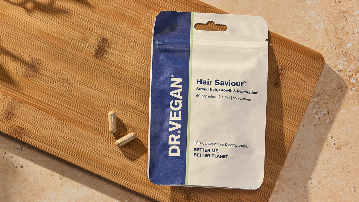 Hair Saviour pouch and capsules on a wooden board