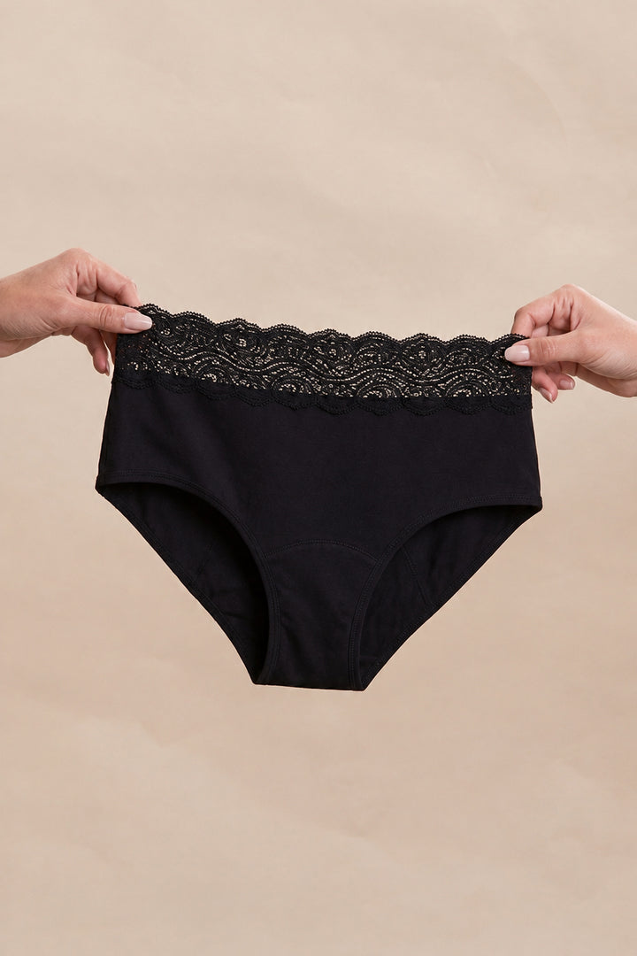 Anthéia period brief held in hands to show size